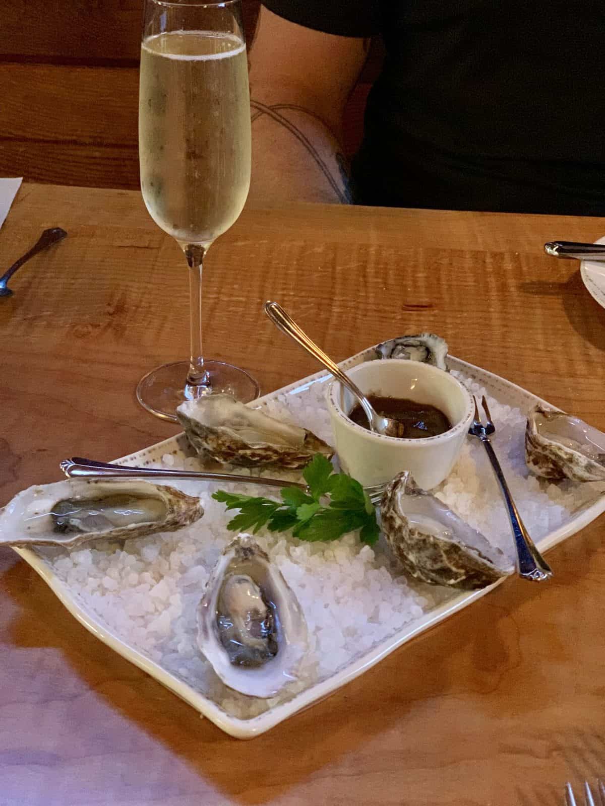 Plate of oysters on the half shell and a glass of champagne