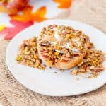 Baked Apple topped with granola, peanut butter, and whipped cream, surrounded by fall decorations