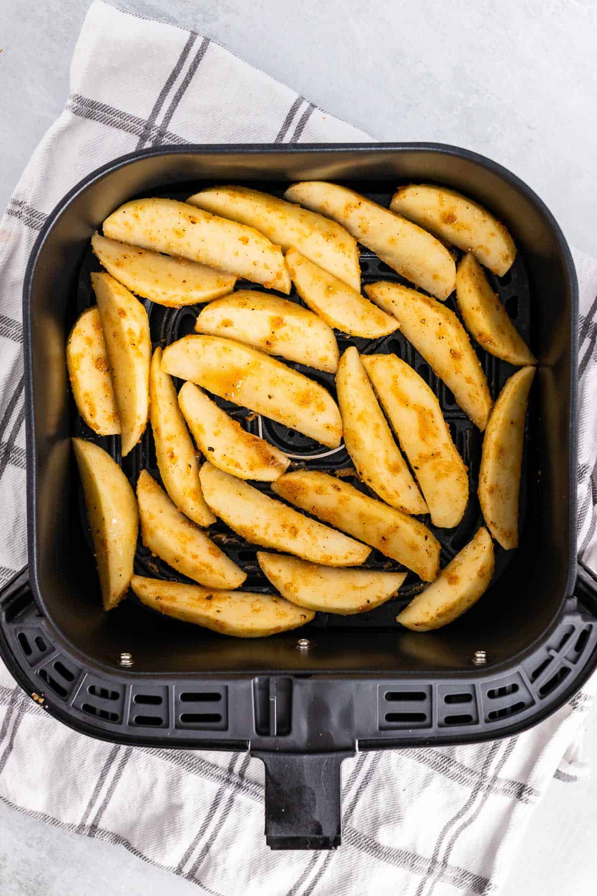 fresh cut potato wedges, tossed in olive oil, garlic powder, onion powder, salt, pepper, paprika and placed in an air fryer basket