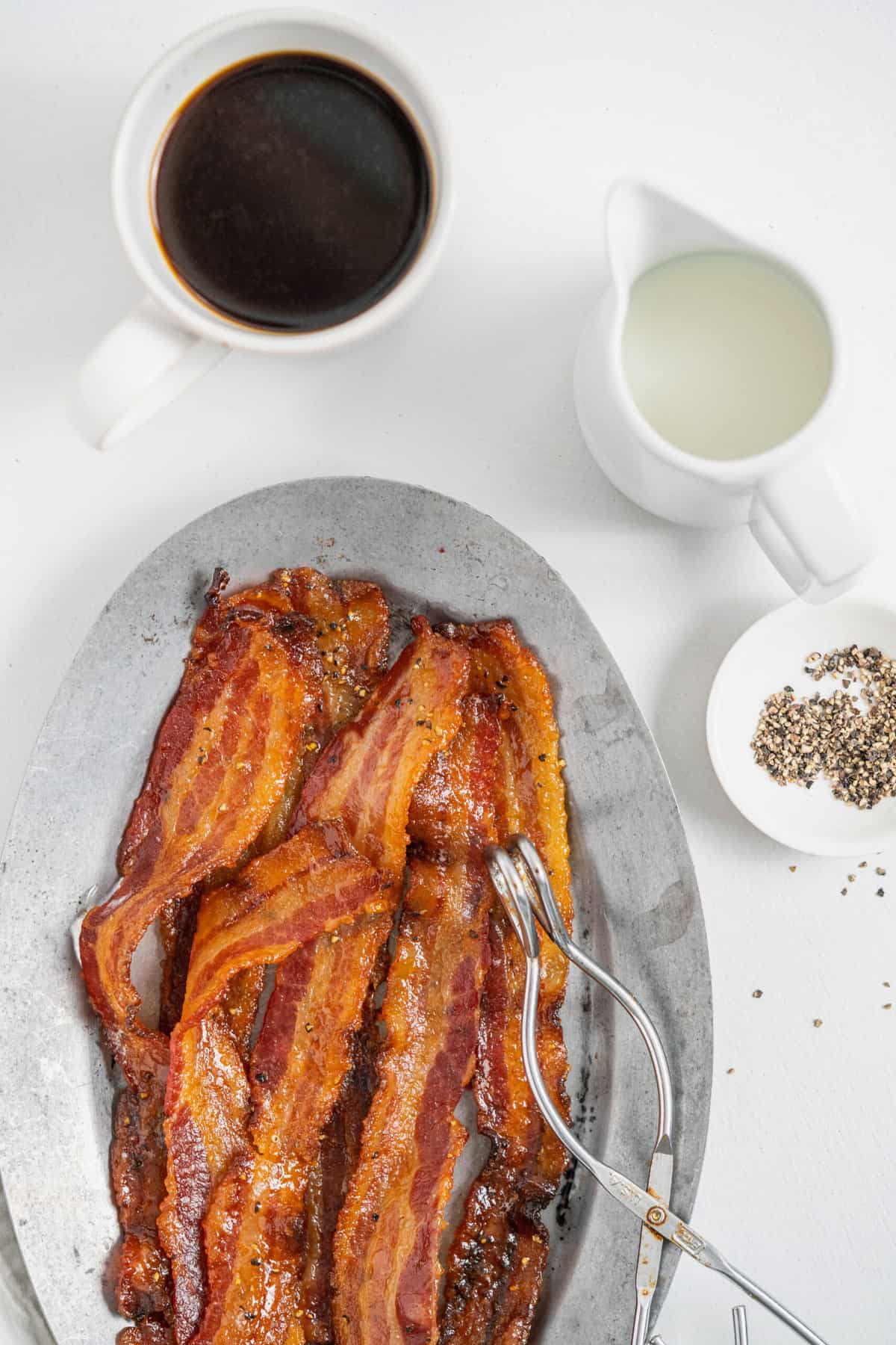 a platter of candied bacon, served with coffee and cream