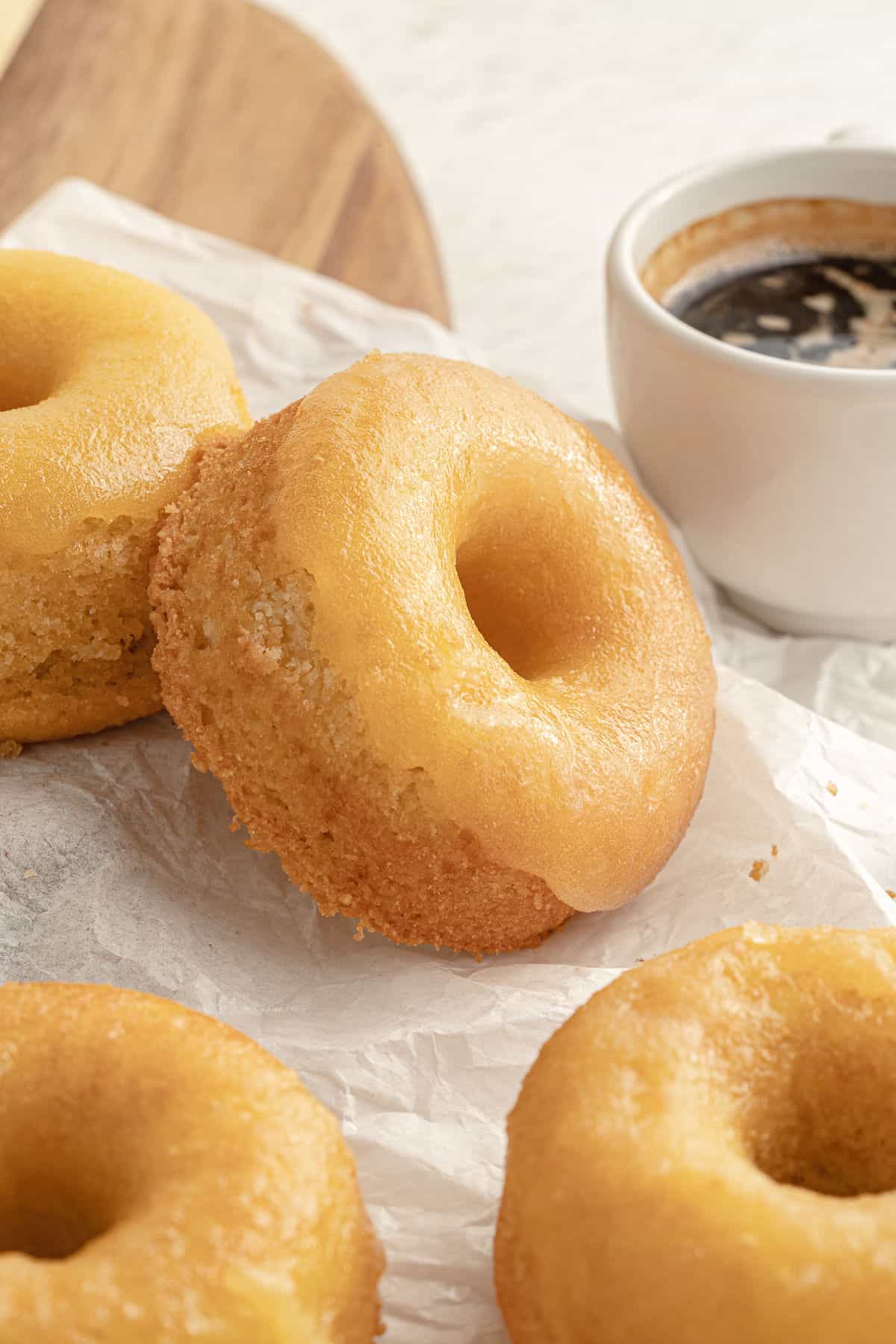 gluten free lemon donuts on parchment paper, served with espresso