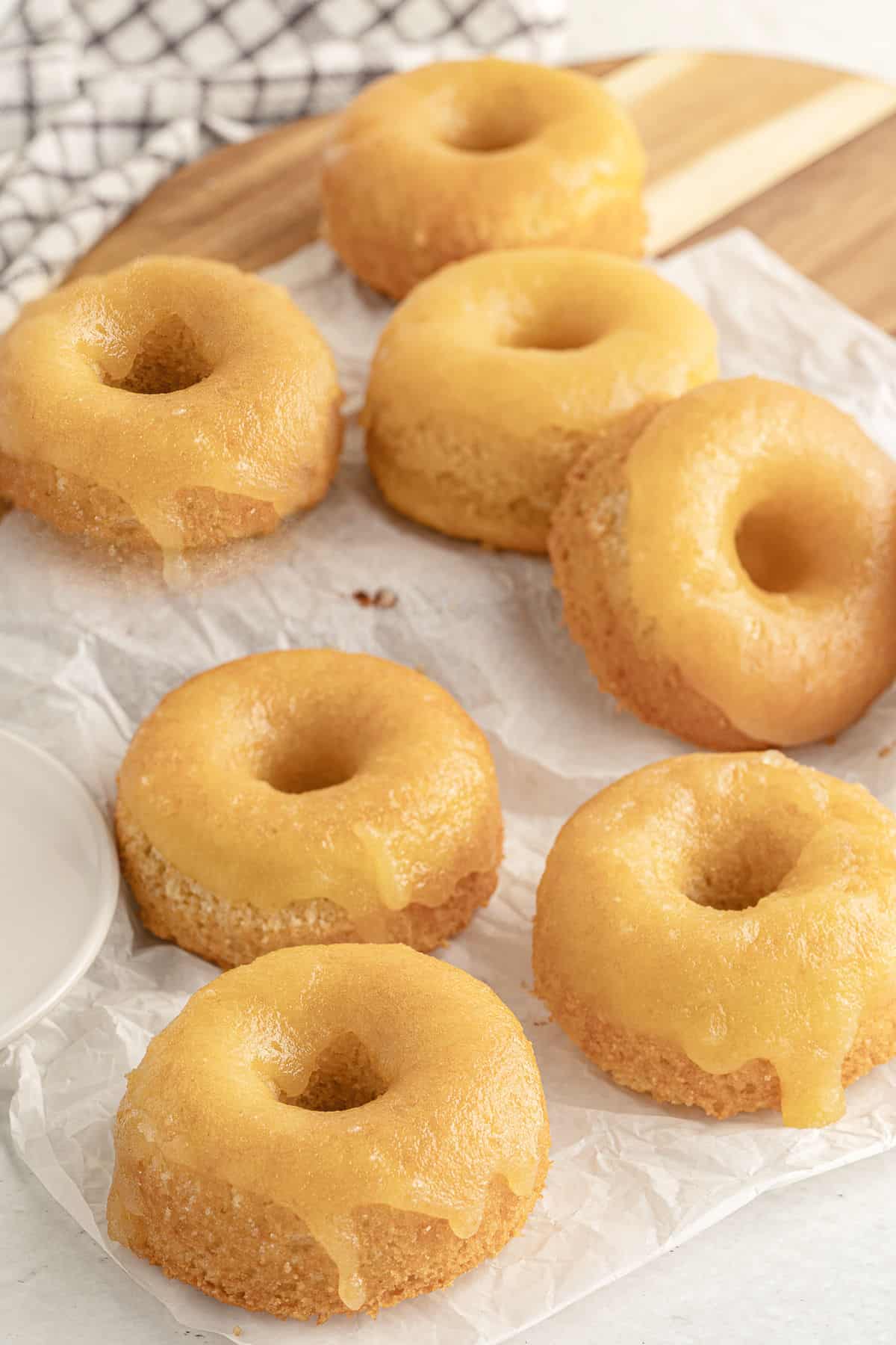 low carb glazed donuts piled up on white parchment paper