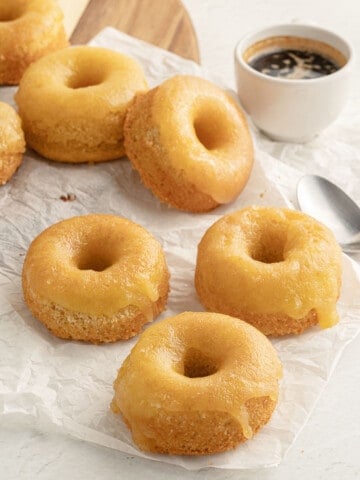 gluten free lemon donuts on parchment paper, served with espresso