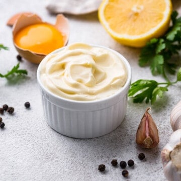 ingredients for a homemade mayonnaise recipe - eggs, garlic, oil, salt, pepper