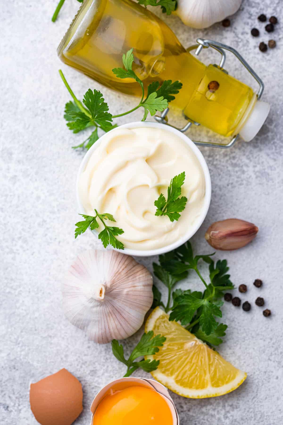 ingredients for a homemade mayonnaise recipe - eggs, garlic, oil, salt, pepper