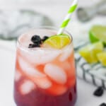 refreshing summer cocktail with tart cherry juice, lime juice, soda water and vodka, served with a green and white striped straw