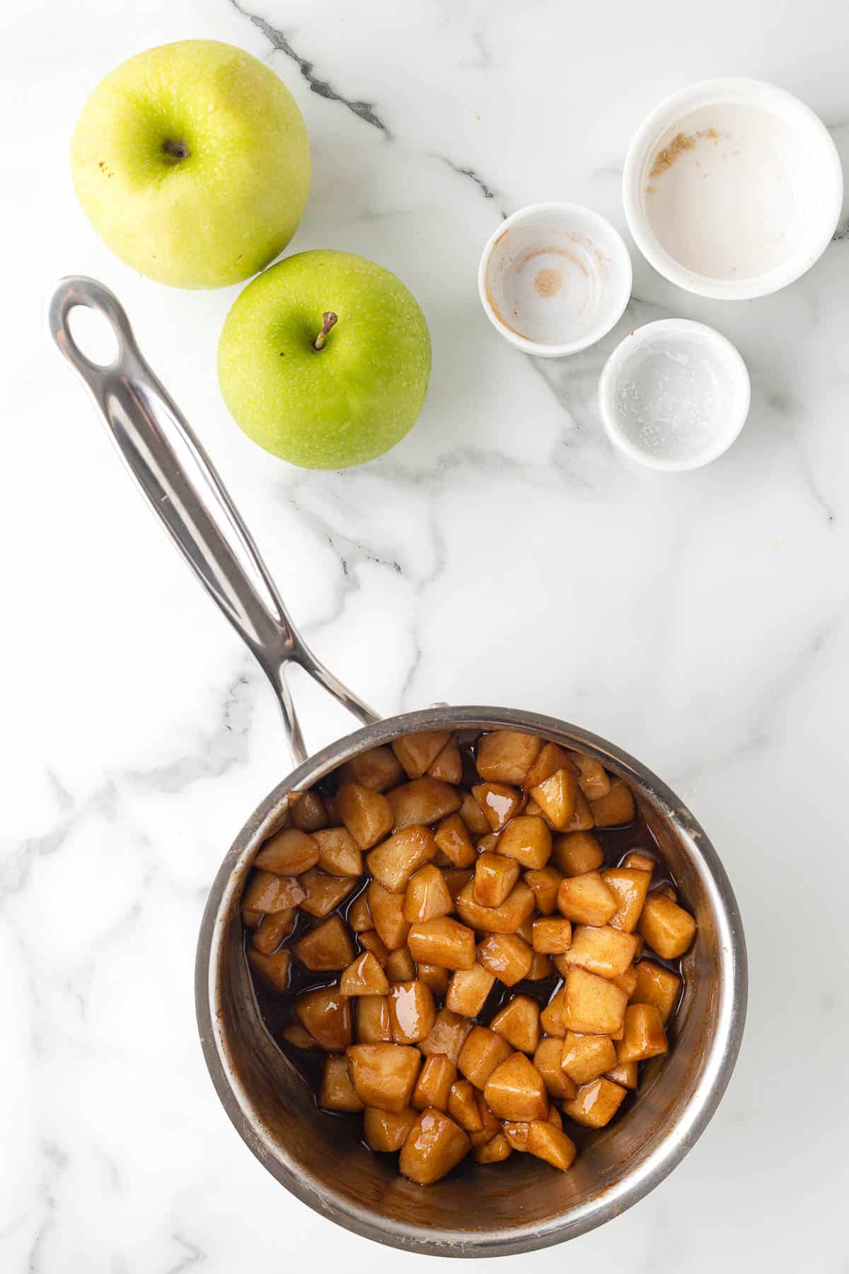 sauce pan with apples, brown sugar, and cinnamon and cornstarch to make apple pie
