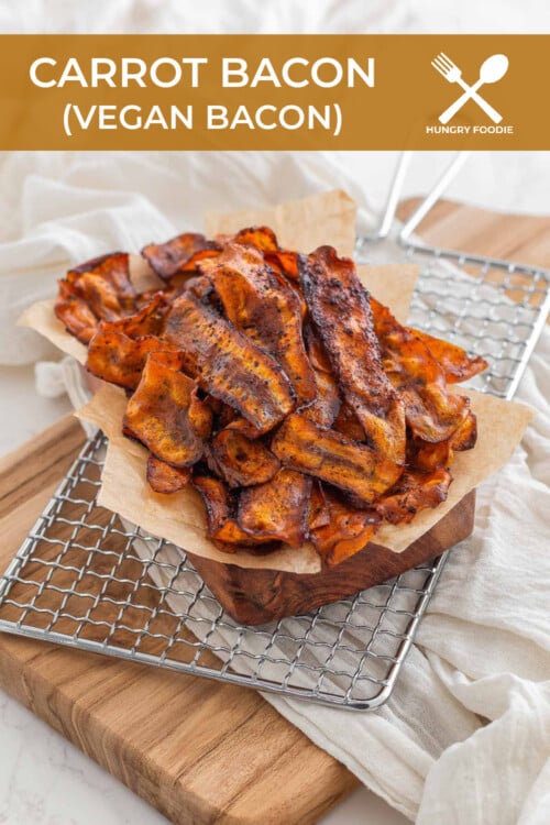 Carrot bacon made out of carrots served on a cooling rack and in a metal dish lined with parchment paper.