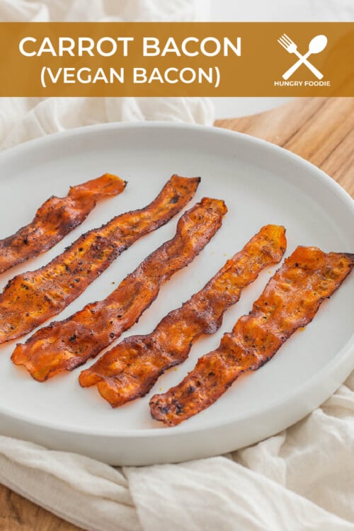 Carrot bacon made out of carrots served on a cooling rack and in a metal dish lined with parchment paper.