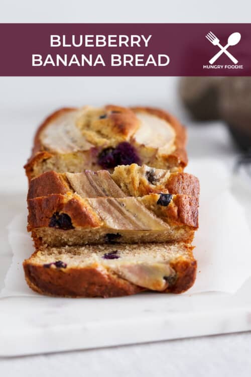 A loaf of blueberry banana bread, right out of the oven and sliced.
