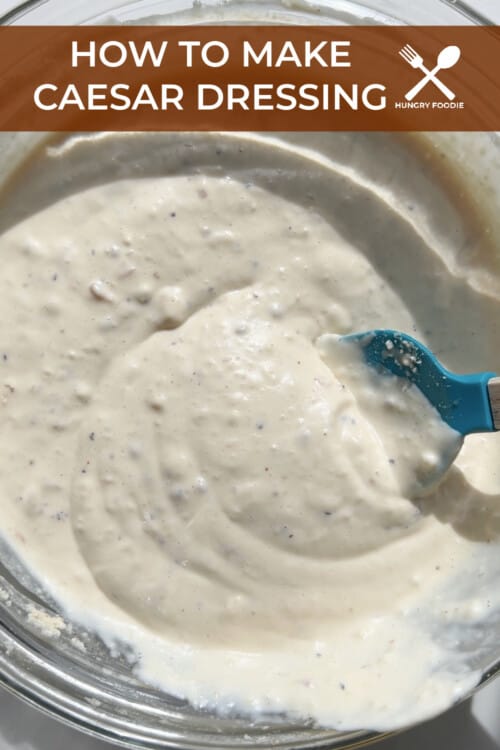 A mixing bowl with mayonnaise, garlic, lemon juice, Worcestershire sauce, salt, pepper, dijon, anchovies and garlic in it.